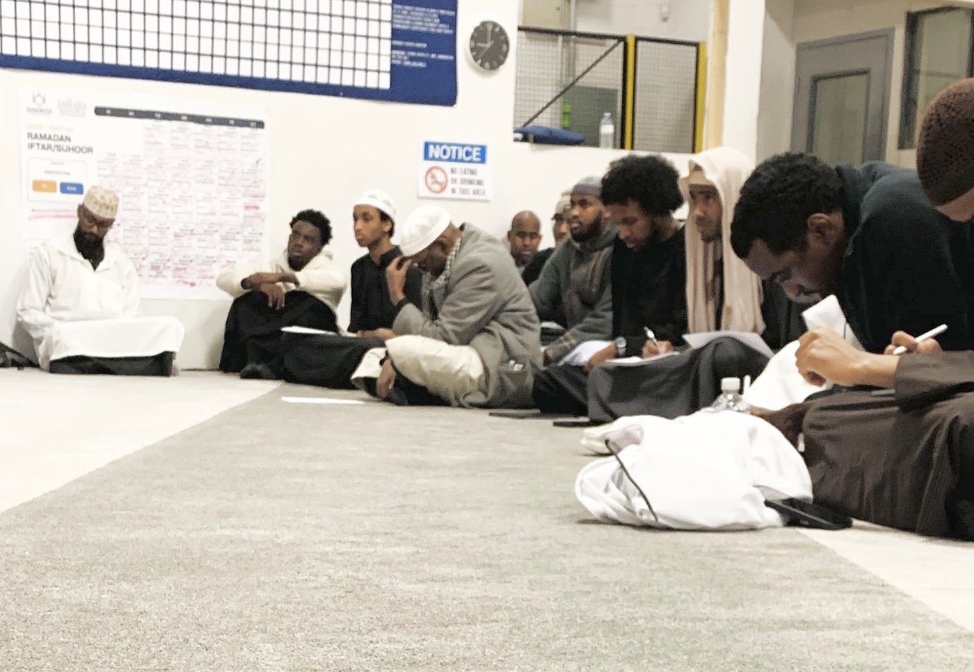 Youth taking notes during a halaqa