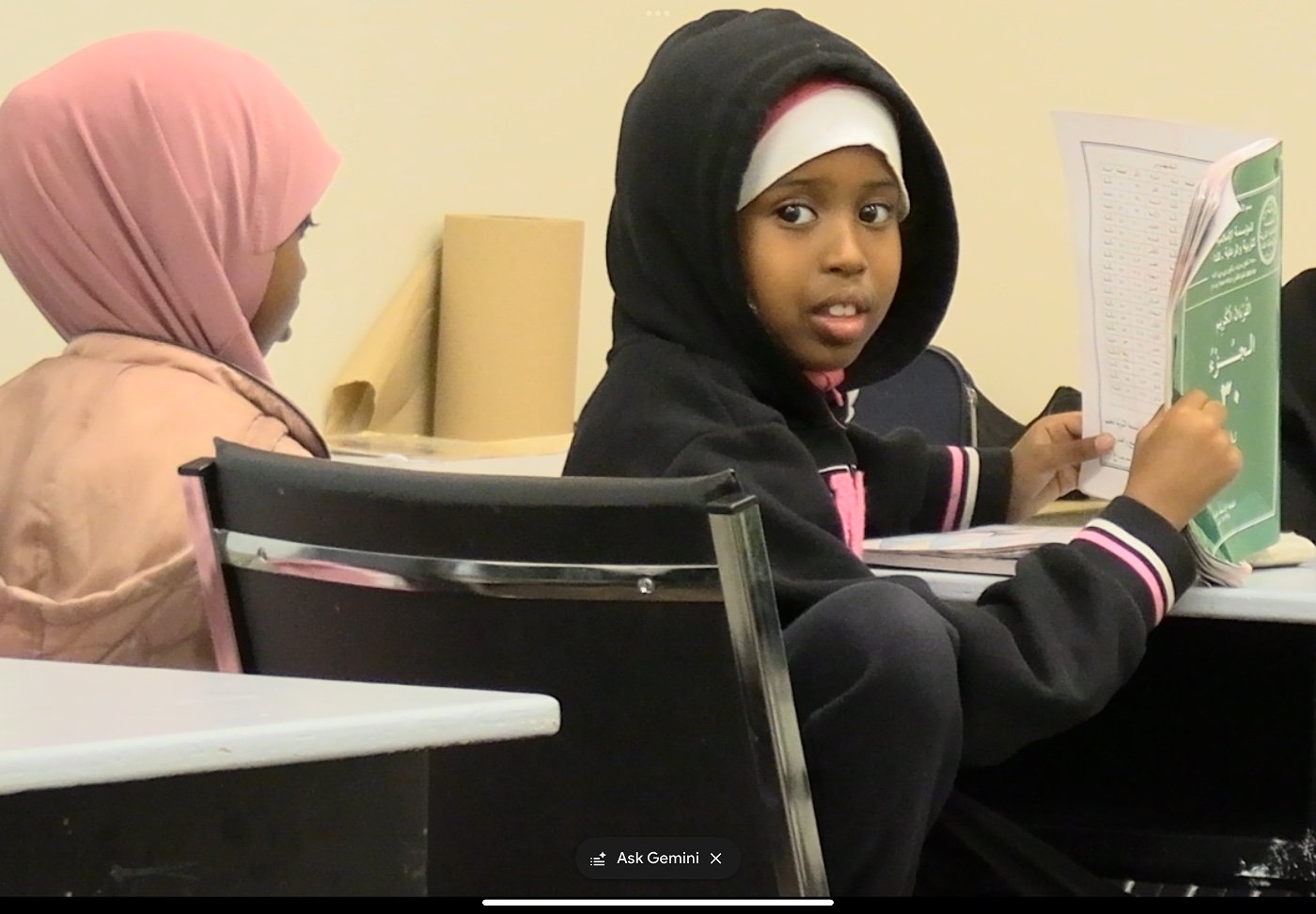 Children seated in the musallah for an Islamic studies lesson