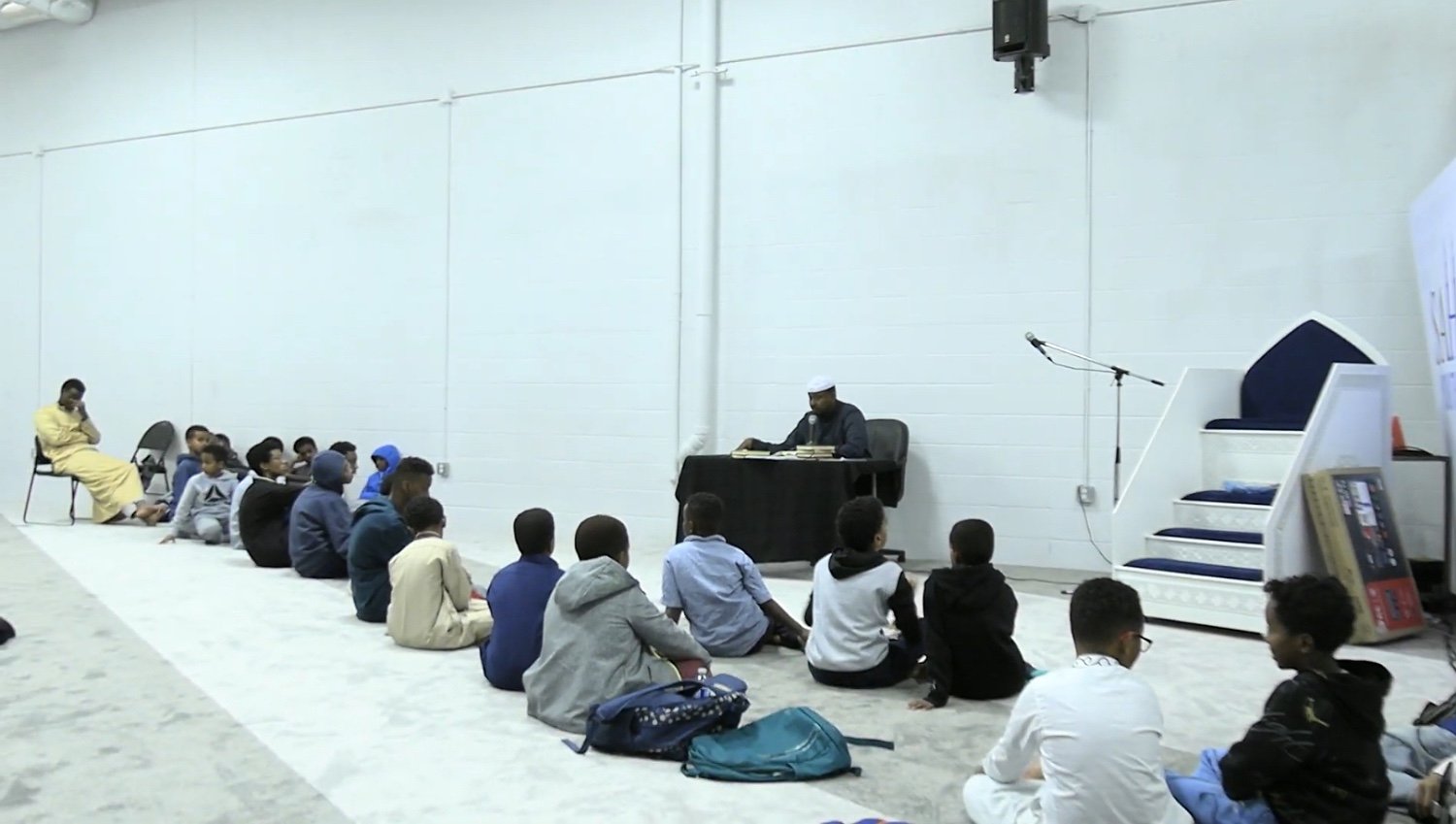 Imam delivering a lecture to the community