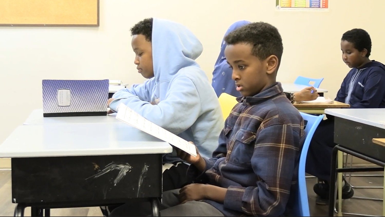 Students reading Qur'an in a Sahaba classroom