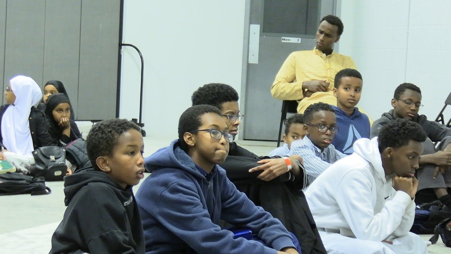 Youth listening attentively at a halaqa